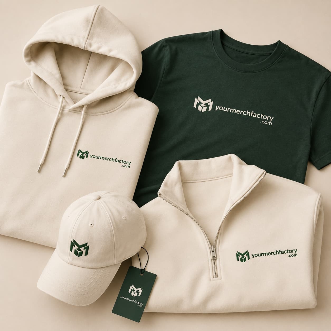 Folded premium custom apparel — heavyweight tees and hoodies — styled on a warm neutral surface