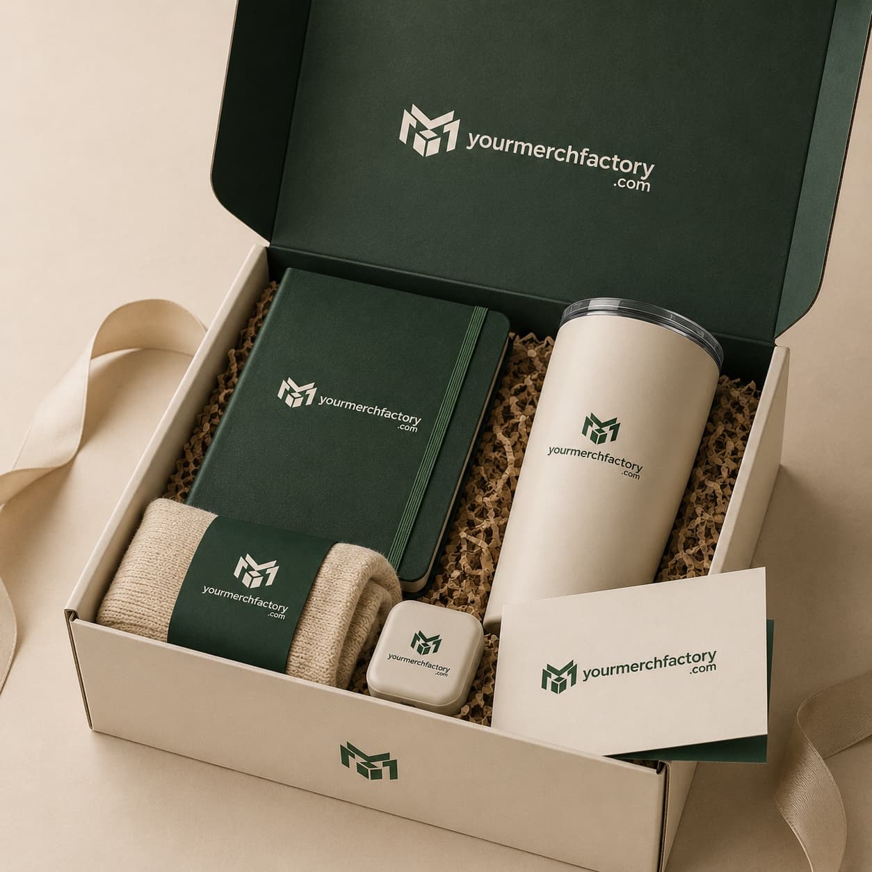 A curated custom gift box with branded apparel, a tumbler, and a notebook